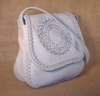  Here is another front angle picture of this braided leather purse using a light colored background. 