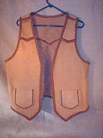  This buffalo (American bison) leather vest was built with leather that the buyer provided - the lacing for it is my moccasin cowhide leather. It has pointed yokes on the front and back, two patch hip pockets (without flaps) that also have matching inside pockets = four pockets in total. Clicking on the link will bring you to a page with more pictures of it. 