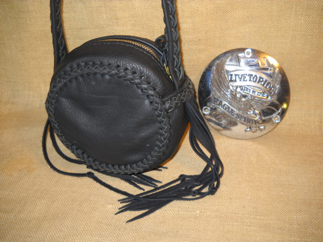  I called this round bag a canteen bag because that's what it rather looks like. It's 9" round by 4". It is made using a braided construction with 1/4" wide laces for the seams, and down the length of the strap. The large brass zipper is hand sewn using 5 ply nylon thread. It also has pretty long tassels hanging from each side. 