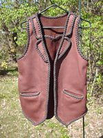  This two tone leather vest has what I've come to call split front lapels. It also has a back pointed yoke, split hip pockets, and a back/bottom draft flap. Clicking on the link will bring you to more/closer pictures of these features. 