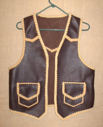  Like all of my work, this custom and handmade leather vest was built to the customers specifications. It has pointed yokes (front and back), and patch hip pockets with flaps. The two colors are both brown tones ...with lots of contrast. 