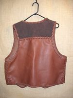  the back side of this two tone brown leather vest 
