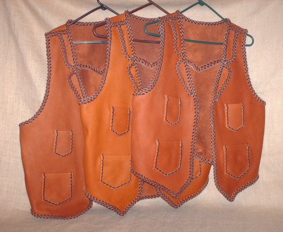  These three two toned vests were all bought by the same guy for his bartender employees. They all have split lapels, pointed yokes on the back, as well as, the four pockets done with a simple braid. All of my work is made in the USA using leather tanned in the USA 