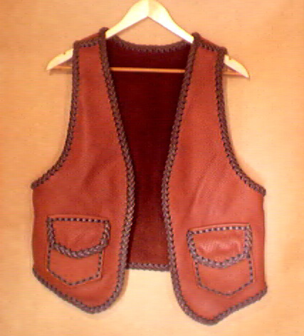  This two tone brown handmade leather vest was custom made in the USA with moccasin cowhide leather that is tanned in the USA. It has patch hip pockets with flaps and, on the inside, it has matching pockets without flaps. 