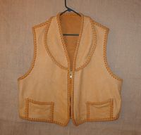  This custom leather vest was fashioned after a vest that the buyer sent me. He also sent me the elk skin to make it with. I decided to use my moccasin cowhide laces as that would make for a stronger vest. It has a shawl collar, two low hip pockets with two more matching hip pockets on the inside (four pockets in total). Clicking on this link will bring you to a page with more /closer views of its features. 