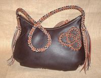 This dark brown and mahogany colored bag has my tri-loop braided applique on one side. 
