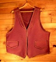  This moccasin cowhide leather vest is completely hand braided. Made in the USA, it has lapels on the front, a pointed yoke on the back, and two slit hip pockets with flaps. Clicking on it will bring you to a page with more details about it. 
