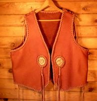  This custom leather vest was made for a guy who sent me his vest to go by when building one for him. He also supplied the snake skin for the inlay. Both the side and shoulder seams were loosely braided (like 'lace up' vests). Of course, I also did the braiding around the snake skin. 