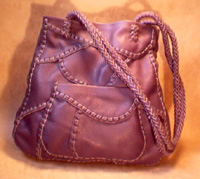  It has the front pocket seen in the picture and another full width pocket on the inside/back. It also has long 8 strand braided straps. 