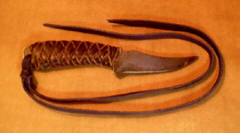 knife handle covered with braided leather
