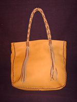  This is the back view of the tote that also shows the braided straps and their long tassels. 