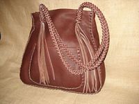  This Mahogany colored large tote was braided using the basic 'stair step' braid. It has quite long 8 strand straps with 8 quite long tassels hanging from them. It also has a full width back/inside pocket.