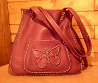  This large leather tote bag has a full width inside/back pocket and a front pocket with a butterfly applique. It can be built in many ways - there are quite a few versions of it on the page it is linked to. 