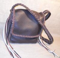  Another braided leather purse for carrying an Apple Ipad - it also has the same two full width pockets as the purse on the left. As usual, the buyer selected the three colors used for it, and the length of the tassels that it has. 