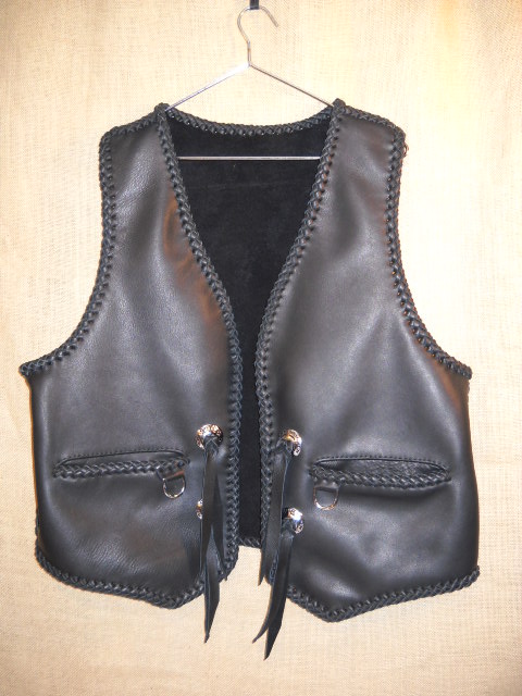  The guy that purchased this vest sent me a vest of his own to get a pattern from. I pretty much add the same features that his vest had. Namely, wide slit hip pockets with a D's hanging from them that he used his own closure on. He also sent me the Harley Davidson conchoes that I add to the vest. 