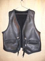  The guy that purchased this vest sent me a vest of his own to get a pattern from. I then did the features like that vest had. Namely, wide slit hip pockets with D's hanging from them that he used his own closure on. He also sent me the Harley Davidson conchoes that I attached to the vest. 