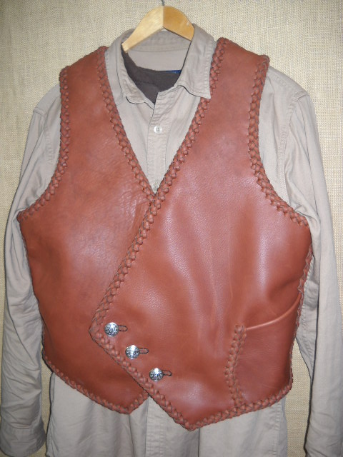  I fashioned this braided leather vest after a picture that a guy want somewhat duplicated. It has the pocket you see in this picture and another similar pocket on the inside - same location. It has the three buttons that the buyer supplied. 