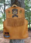  The back of this vest has fringe hanging from the yoke. It also has a 3" 'draft flap' across the back/bottom. The beading and all of the patches (front and back) were added by the buyer ...who took these pictures of it. 