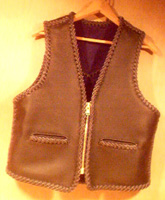  This black leather vest had slit pockets and a large brass (YKK #10) zipper. It has a back pointed yoke and unlike the majority of my vests, the bottom is squared off all around its whole length. I probably added a zipper pull after the picture was taken. 