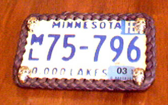license plate framed using braided leather