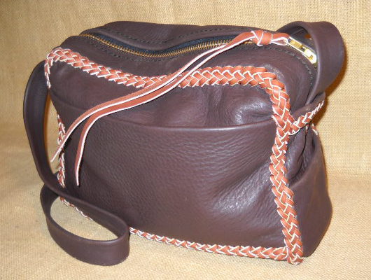  This two-tone messenger bag is about 12" wide by 10" wide by 4". I like the fact that these wider than high bags have a longer zippers. This bag has four pockets - three on the outside (front and sides) and one on the inside back. The 36" long strap on this one is not braided. 
