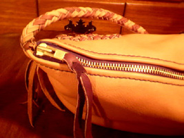 handmade and custom leather handbags and purses using large brass zippers for closures.
